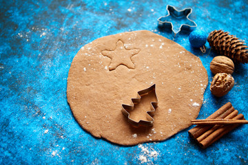 Christmas baking concept. Gingerbread dough with different cutter shapes