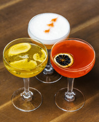 3 different fresh alcohol cocktail at a restaurant interior 