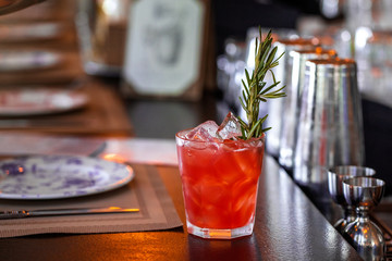 fresh red alcohol cocktail at a restaurant interior 