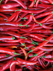Shiny red peppers background