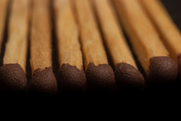 match heads with gray, close up, macro, black background, fire safety concept