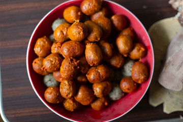 bowl of small artisan sausages on a wooden table - top view - latin sausages
