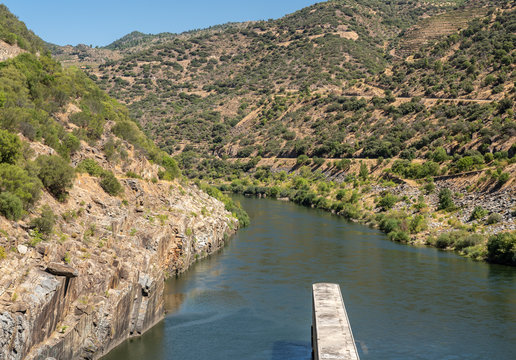Solid structure of the Valeira dam on River Douro looking down into the gorge and narrow canyon