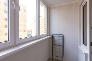 Small glazed balcony in the apartment of a residential building