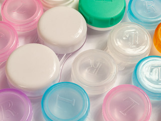 containers for soft contact lenses, multi-coloured, plastic, for cleaning and storage, close up