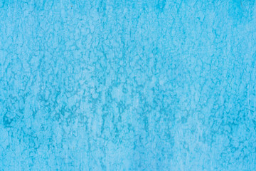 Texture blue paint peeling from wall from old age. For background