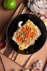 cooking spicy instant noodles soup with shrimps and  mushrooms. flat lay.