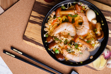 spicy instant noodles soup with shrimps and  mushrooms. flat lay.