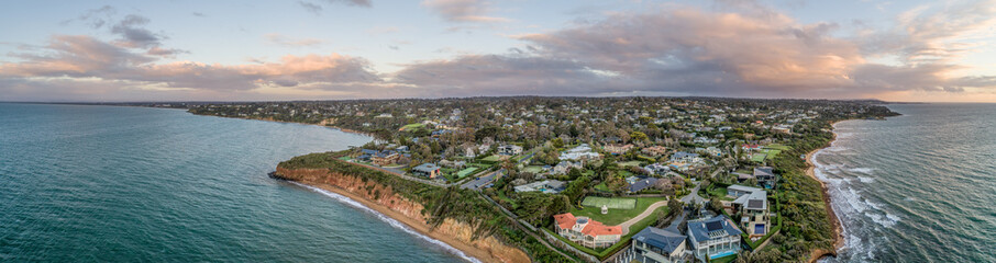 Fototapeta na wymiar Wide aerial panorama of Mount Eliza suburb luxurious real estate on Mornington Peninsula at sunset