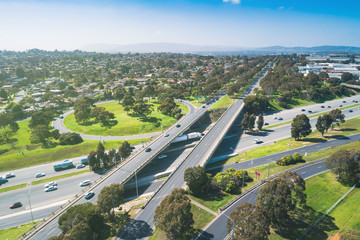 Highway interchange in bright sunlight with harsh shadows in Melbourne, Australia - aerial view