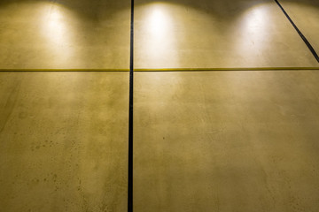 Polished concrete interior wall panels in diminishing perspective and dim light with copy spalce
