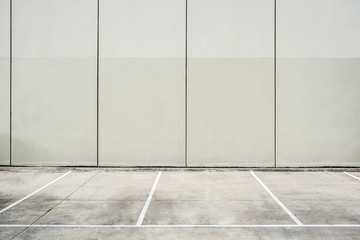 Empty parking lot next to concrete wall - clean geometric architecture shapes with copy space © Greg Brave