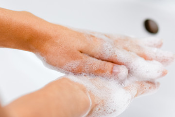 Fototapeta premium Hygiene concept. Washing hands with soap under the faucet with water