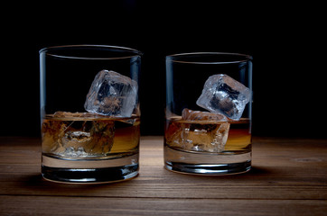 two glasses of whiskey with ice