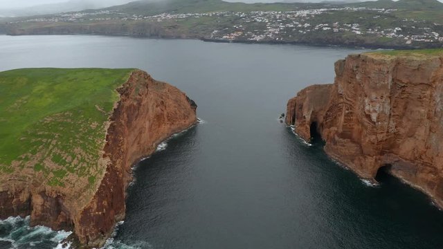 Volcanic islets in the ocean and coastal towns of Terceira islend. Aerial of Azores