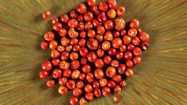 Chili tepin peppers 4k video spinning clockwise slowly top down view