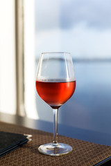 Glass of rose wine closeup on table