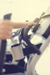 Cardio workout on an elliptical machine in gym