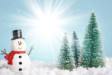 Christmas greeting card. Snowman and new year trees on snow over blue paper background