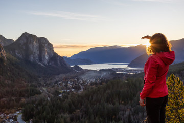 Adventurous Girl Hiking in the mountains during a sunny Autumn Sunset. Taken Squamish, North of Vancouver, British Columbia, Canada. Concept: Adventure, freedom, lifestyle