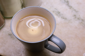 Close up of a cup of a latte coffee in a real everyday kitchen just made at home for breakfast