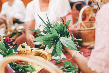 Thai people make merit by offer food and flower to the monk and pray to the Buddha in temple.fresh flowers for make merit, Thai style traditional.