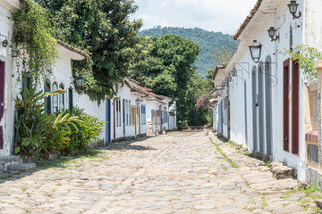 Fototapeta na wymiar Street and old portuguese colonial houses in historic downtown in Paraty, state Rio de Janeiro, Brazil