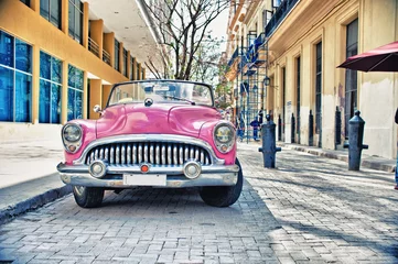 Zelfklevend Fotobehang Old Buik pink car parked in a street of havana city © javier