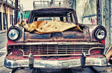 Old american car broken in a street of havana