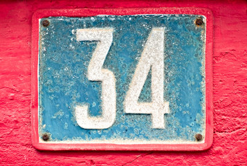 Number 34, thirty-four, blue on pink background.