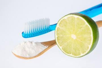 Fresh sliced lime, baking soda and toothbrush