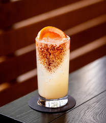 fresh grape and lime alcohol cocktail at a restaurant interior 