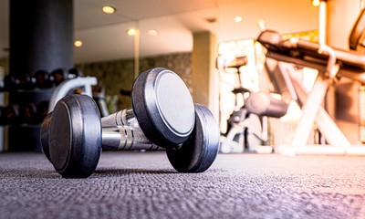 Dumbbell on the floor in luxury fitness club at the morning , Concept for healthy lifestyle