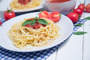 Spaghetti pasta with and tomato sauce on wood background