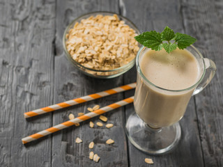 Two cocktail tubes and an oatmeal smoothie with mint. Vegetarian smoothie.