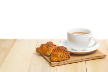 Coffee and croissants on the wood