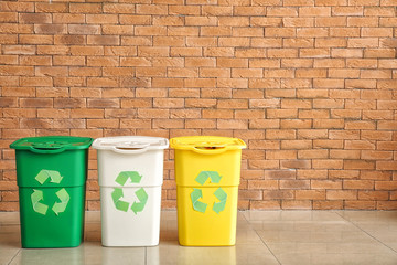 Containers for garbage near brick wall. Recycling concept