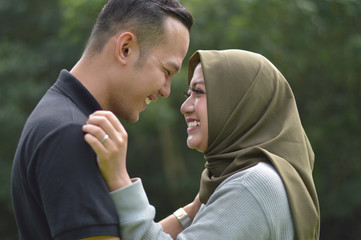 lovely asian Muslim young couple embracing at outdoors