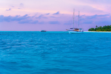 Fototapeta premium Yacht near the pier of a fabulous island in the Maldives.