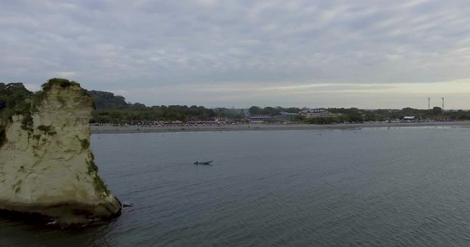 Panoramic View of the Beach and Stone Shaped Like a Piece of Cheese
