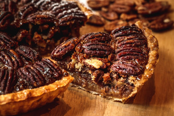 Fresh baked maple walnut pecan pie on a brown wooden background