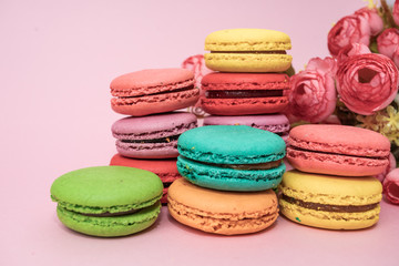 tasty colorful macarons on pink background