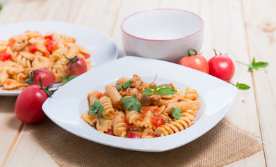 Spaghetti pasta with and tomato sauce on wood background