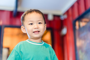 portrait of a cute little boy talking with his mother in restaurant