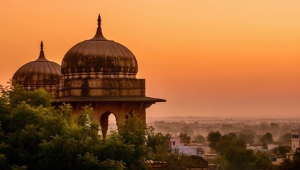 Traditional north Indian palace domes in low light, almost silhouetted against the beautiful dawn sky, in Mandawa, Rajasthan, India. 