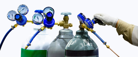Oxygen cylinder and regulator gauge in factory, equipment isolated on a white background