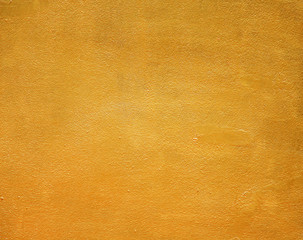 Gold orange paint sparkle colorful bright paint on concrete wall abstract texture in rough seamless patterns for colorful background