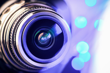 The camera lens with blue and purple  backlight. Macro photography lenses. Horizontal photo.