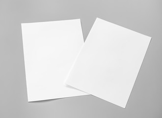 Poster mock-ups paper, white paper isolated on gray background, Blank portrait A4 brochure magazine, can use banners products business cards to showcase your.