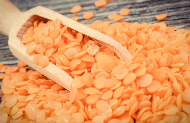 Heap of red lentil with wooden spoon. Healthy lifestyles and nutrition